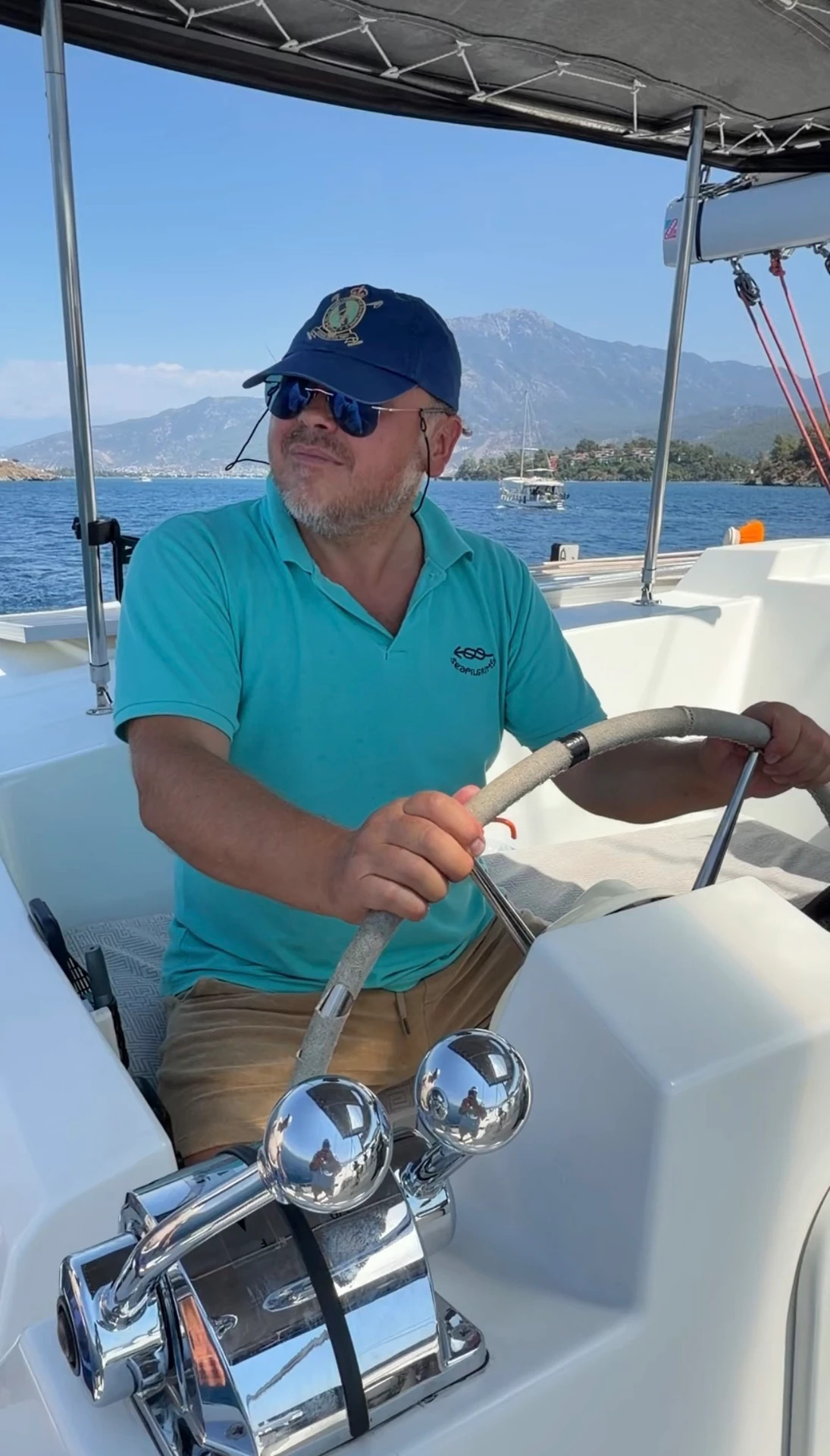 Skipper at the helm of the training catamaran