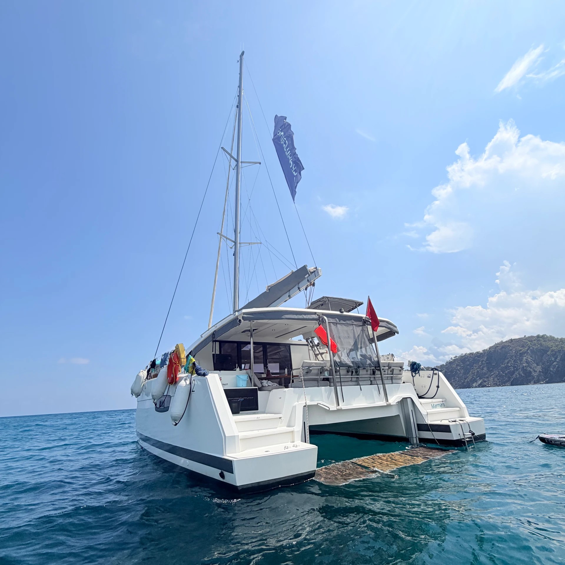 The catamaran anchored in a turquoise bay